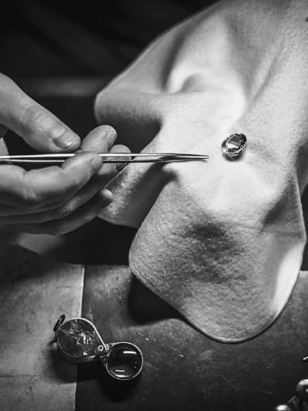 Diamond being inspected with tweezers