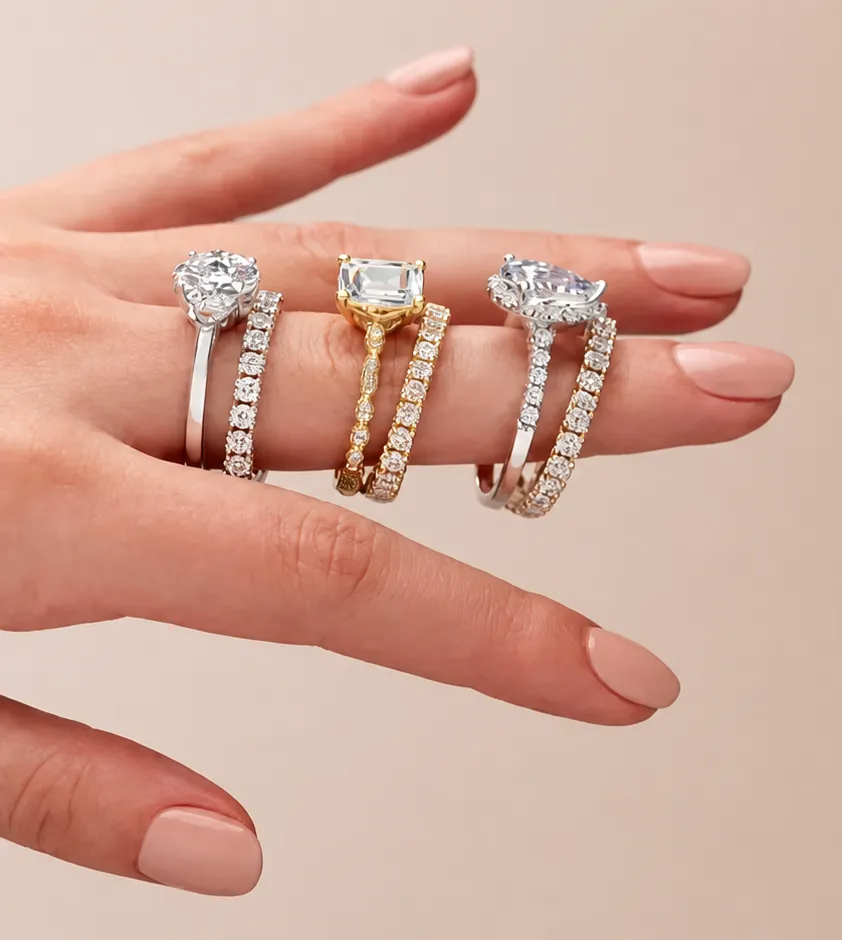 Diamond rings and eternity bands worn stacked on a hand